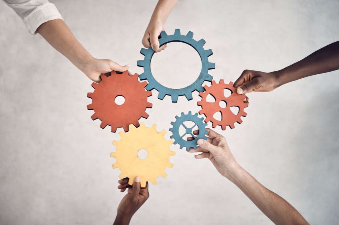 Business people holding cogs demonstrating operational efficiency