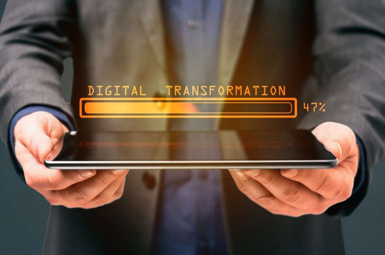 Businessman holding tablet with digital transformation loading representing how Ontario small business grants can help companies adopt new technology