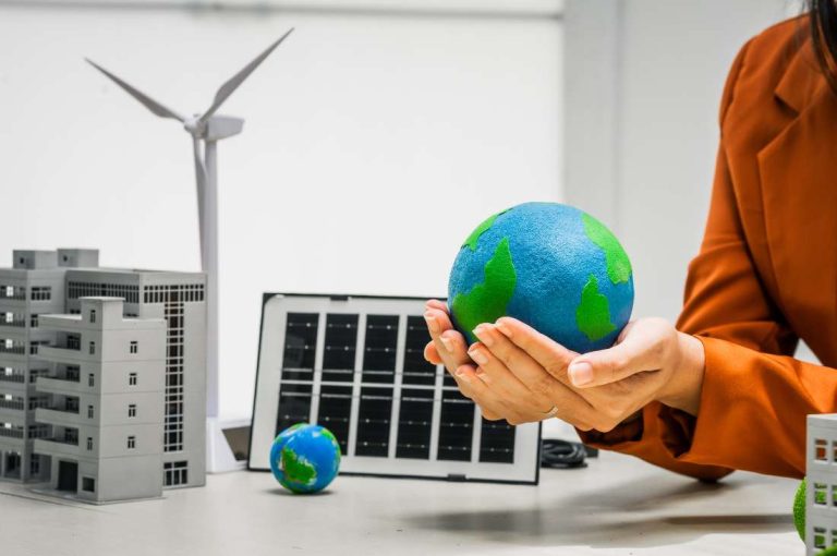 Businesswoman holding globe among green tech representing clean technology tax incentives included in federal budget 2025