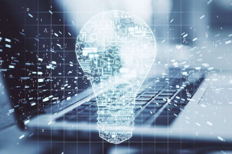 Lightbulb superimposed over laptop representing intellectual property grants