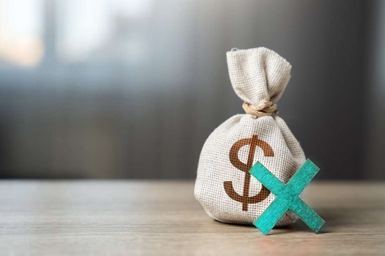 Cross in front on money bag representing the cancelled CEI and other Canadian business tax changes 2026