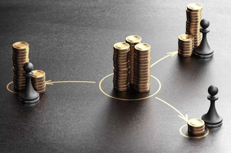 Piles of coins moving with chess pieces representing tax planning for the 2026 Ontario small business tax rate drop